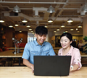 two interns at a computer