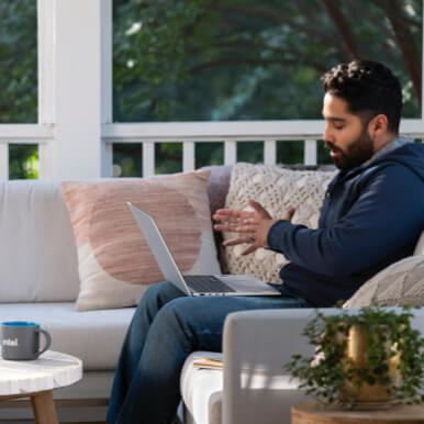 Man working on a laptop while sitting outside