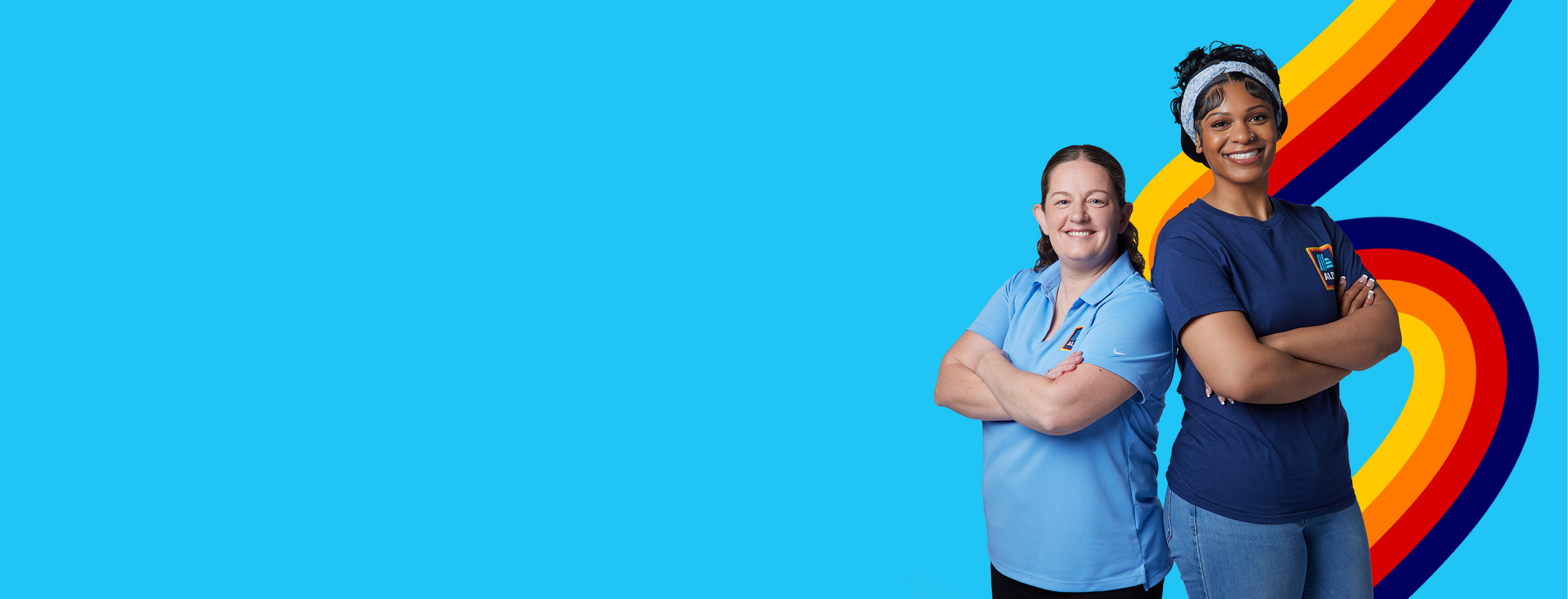two employees facing forward smiling