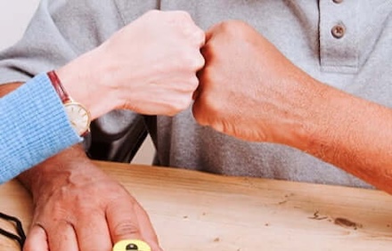 Hands with knuckles touching