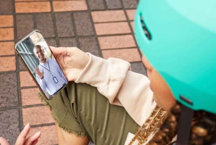 Skateboarder using telehealth on their phone
