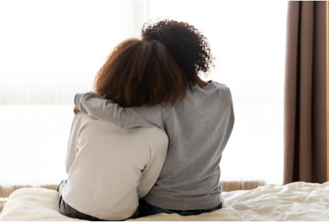Two women hugging