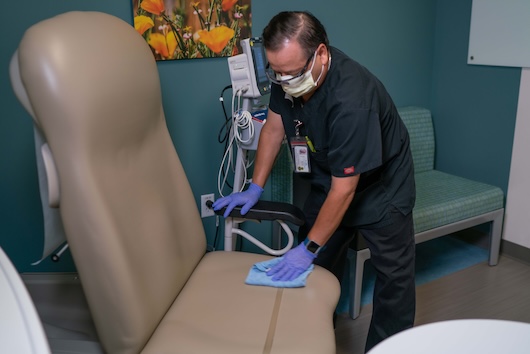 Man cleaning patient room