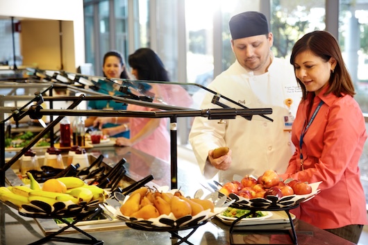 Chef and hospital employee by buffet