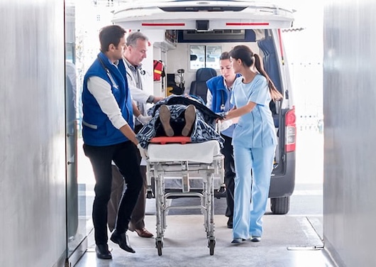 Emergency nurses by ambulance with patient