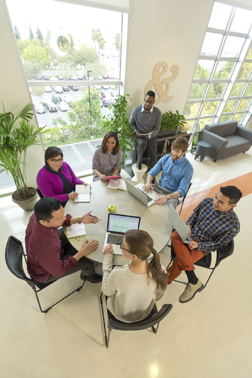 Group of colleagues conversing at a table