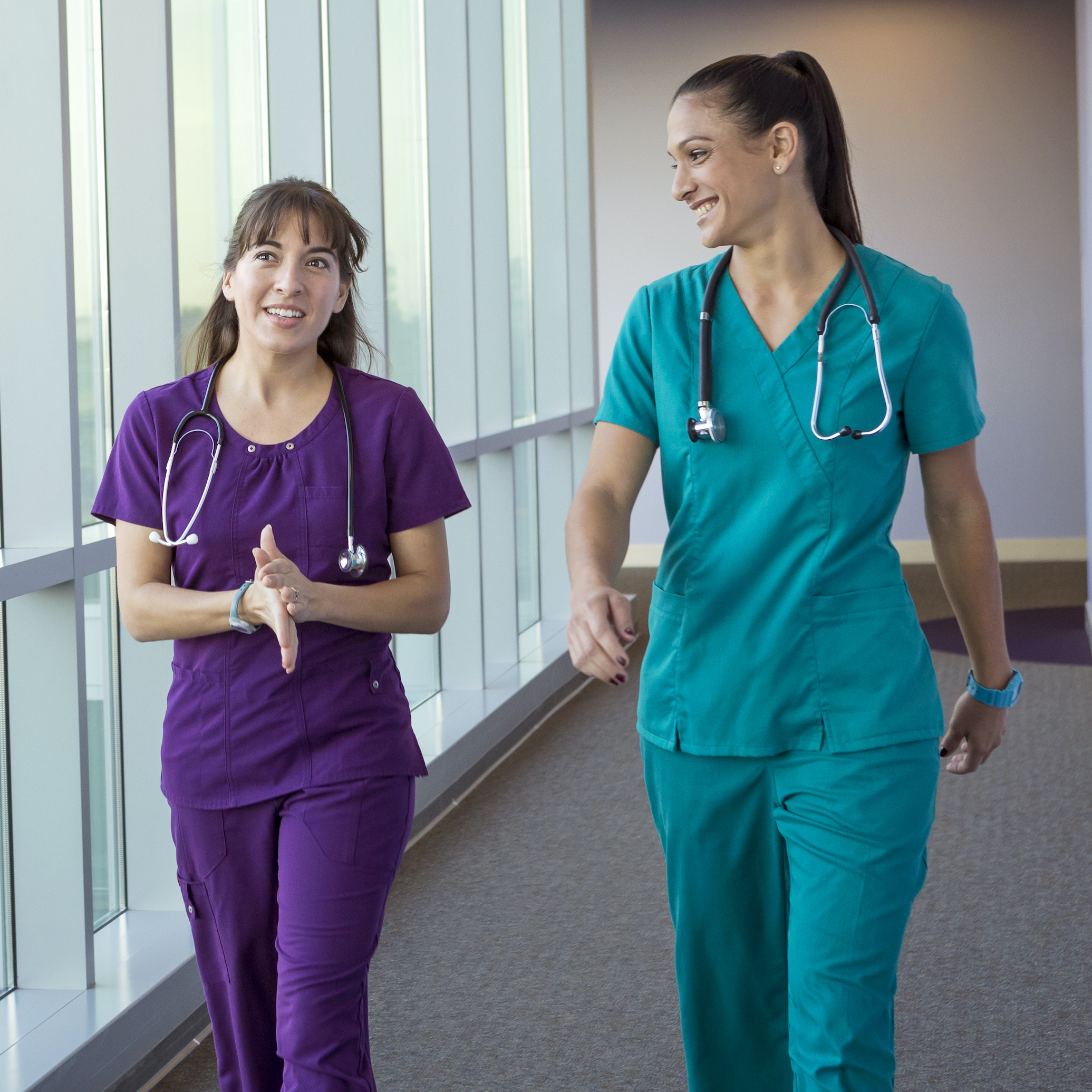 Two nurses walking in hallway