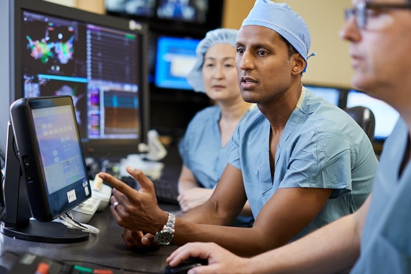 Doctors looking at a screen in operating gear