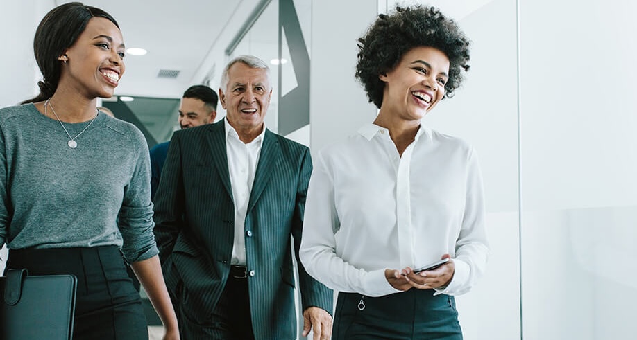Coworkers smiling and walking