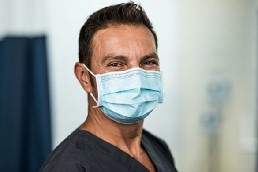 young man wearing ppe mask