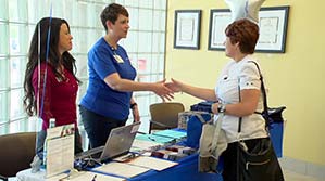 A physical therapist and a job-seeker shaking hands