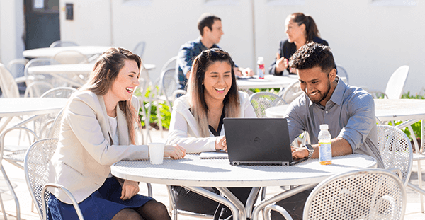Image of Lockheed Martin Employees at a table outside.