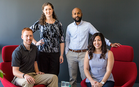 Group of employees pose for photo