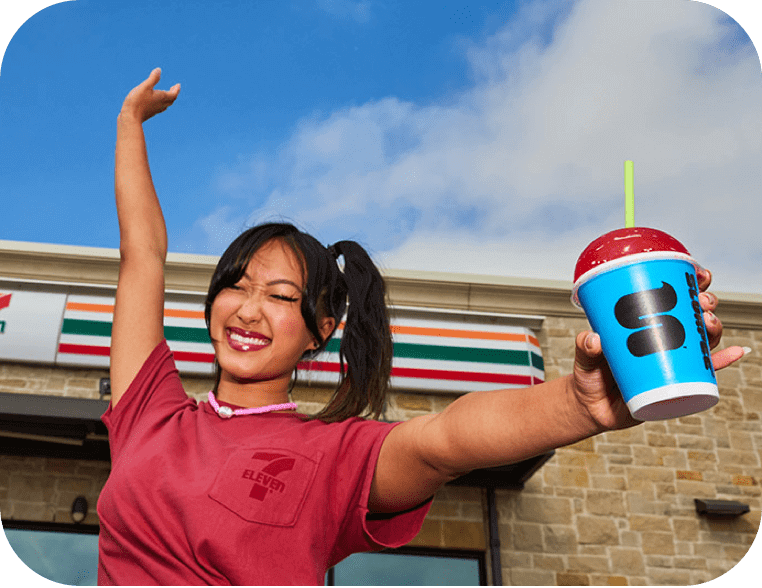 young employee hllding a slurpee cup