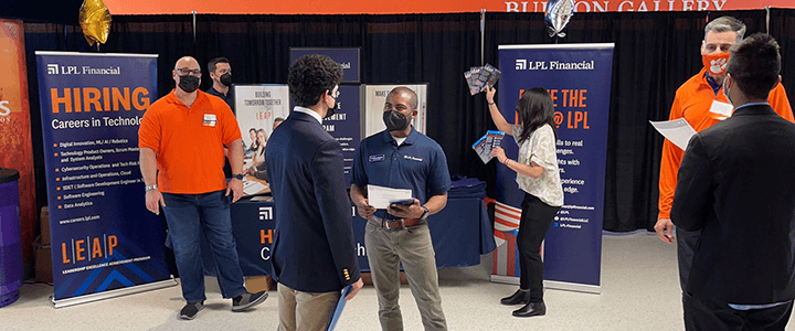 recruiters talking to students at a career fair