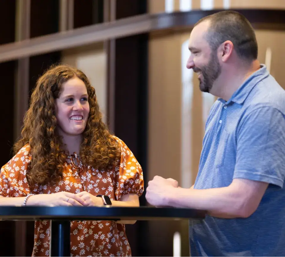 Two people smiling at a table
