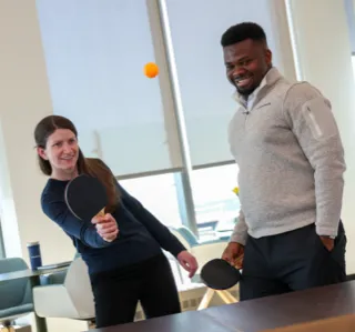 two employees playing table tennis