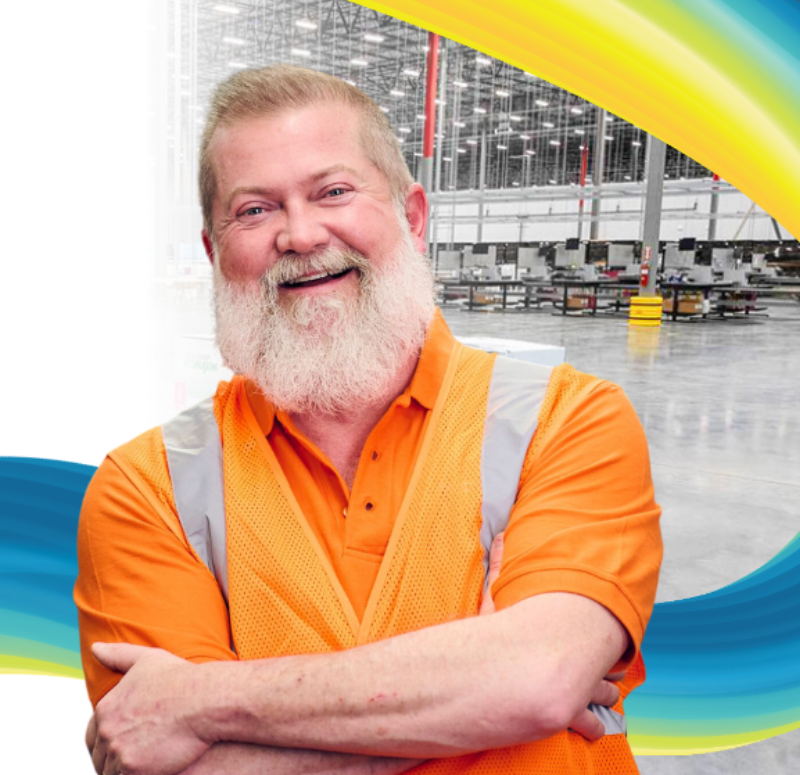 man in distribution center smiling