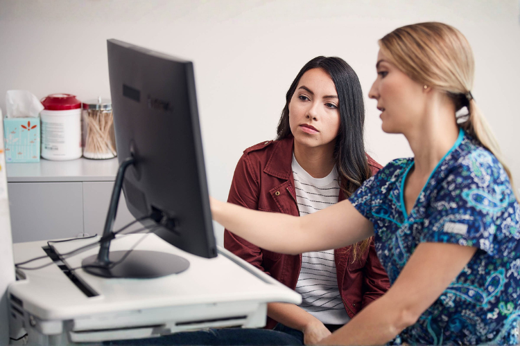 Nurse and patient looking at a computer
