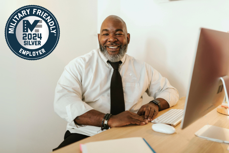 man working at computer smiling