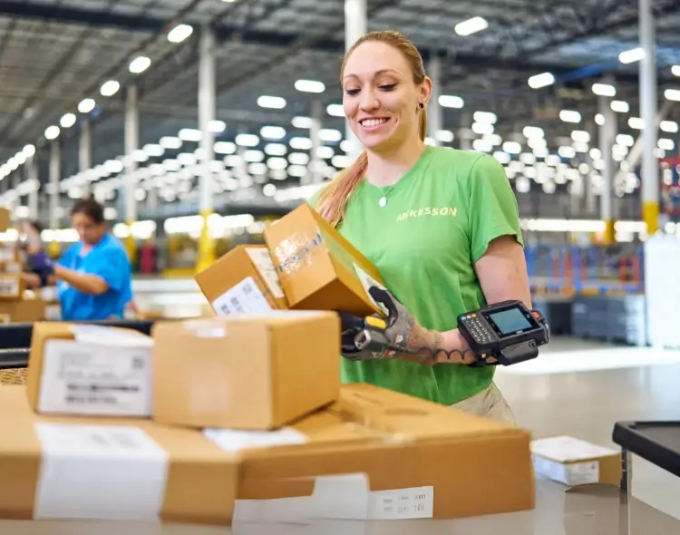 a woman employee inpecting a package box