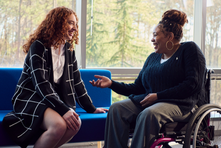 Two women smiling in conversation