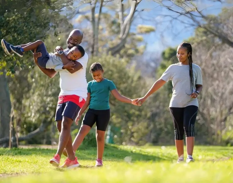 Parent walking with 3 kids