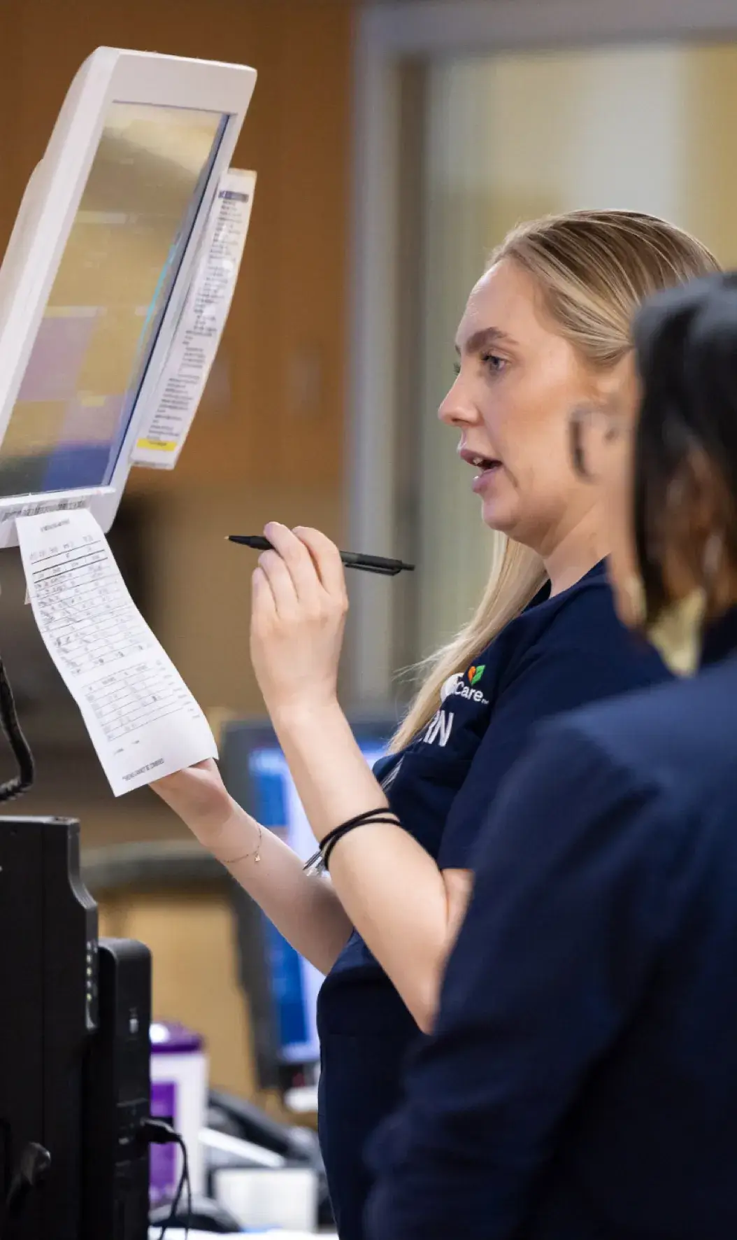 Nurse at the computer looking at patients files