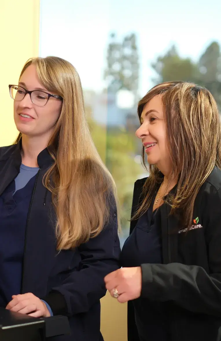 two employees smiling