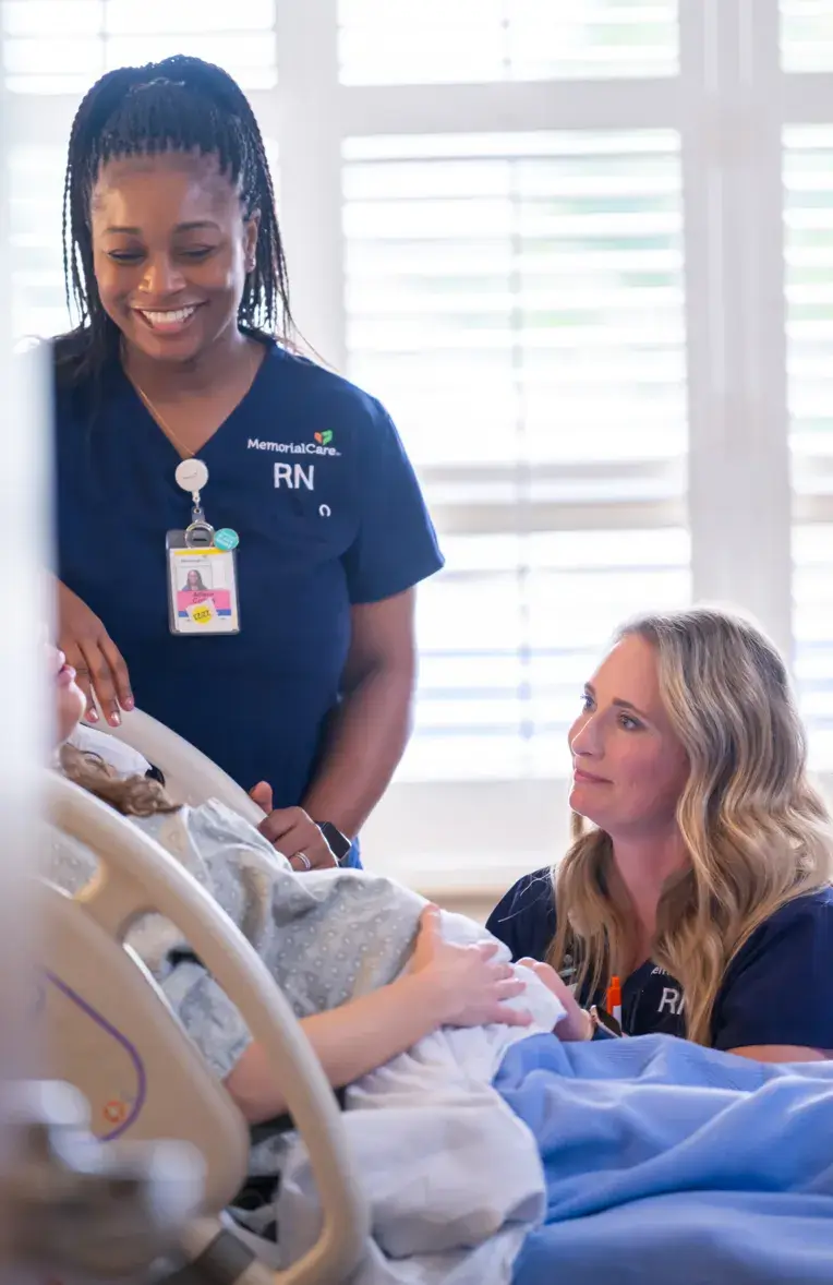two nurses speaking with patient