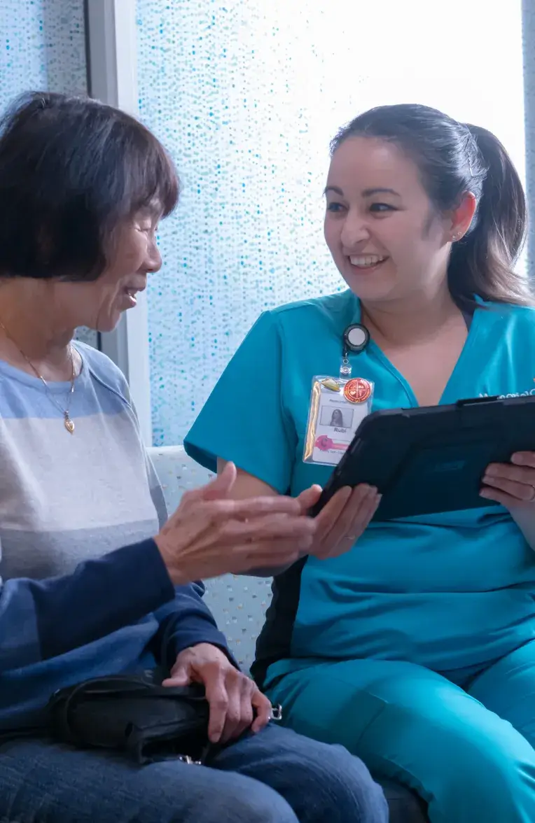 employee helping a patient with forms