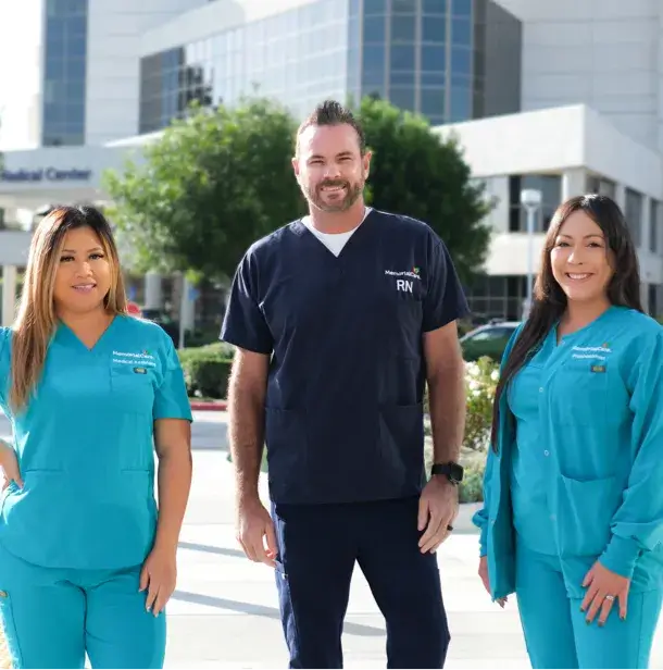 three employees standing smiling