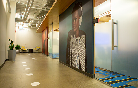 Photo of mural of a woman wearing headphones in an office building