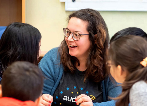 Audible volunteers forming a circle with hands