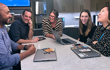 A group of employees conversing in the break room
