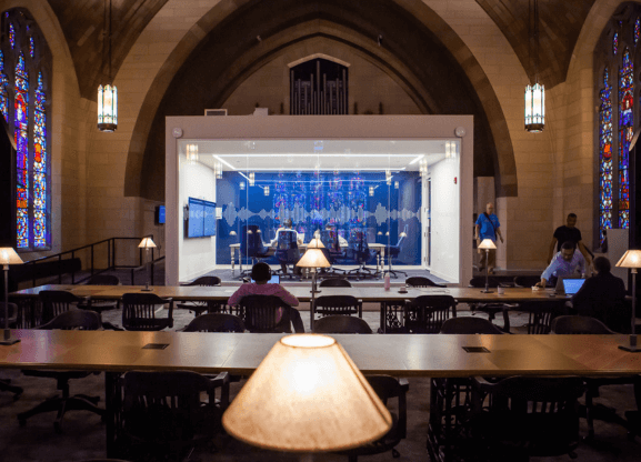 People viewing an audio book recording in a library