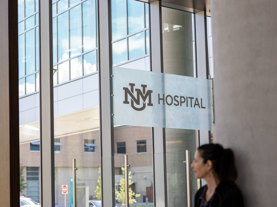 UNM Hospital sign inside a modern hospital building