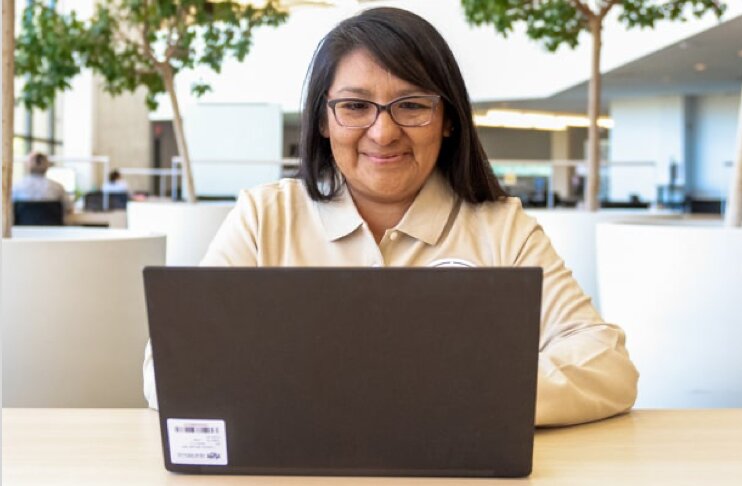 Women sitting on couch with laptop creating a readyset account