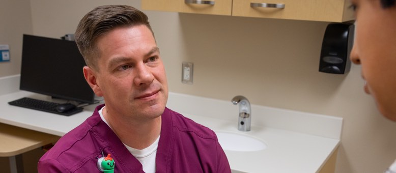 social worker in maroon scrubs