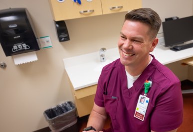 Social Worker in maroon scrubs