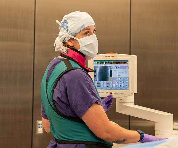 Marjorie A., X-Ray Tech, assisting with surgery