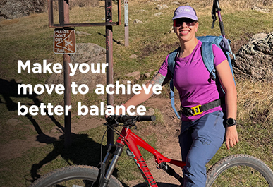 Ruth, a team member from UNM Hospital, smiling posing with a mountain bike