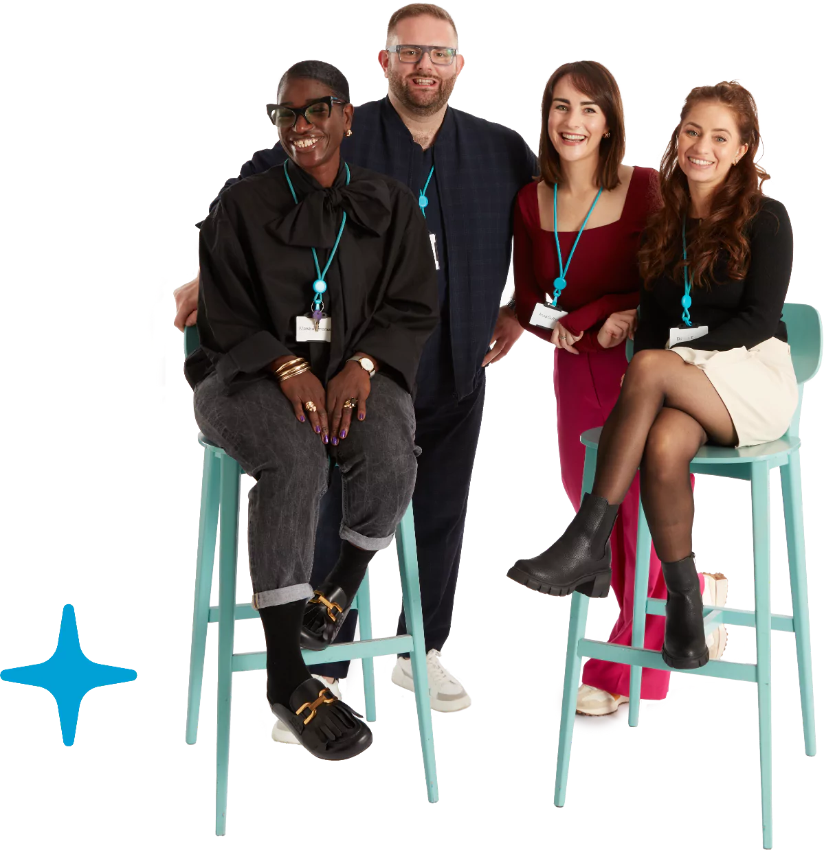 A group of 4 people smiling, 2 are sitting on chairs