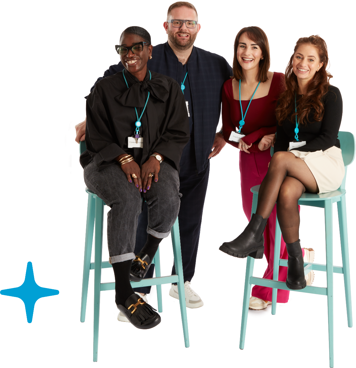 A group of 4 people smiling, 2 are sitting on chairs