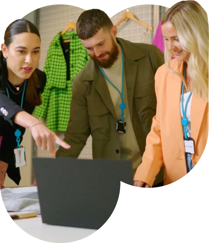 People hovering over a laptop