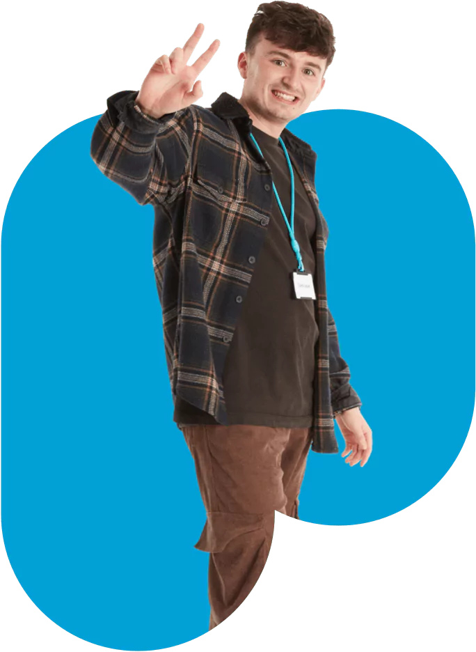 Plaid shirt man with blue polka dot tie showing peace sign.