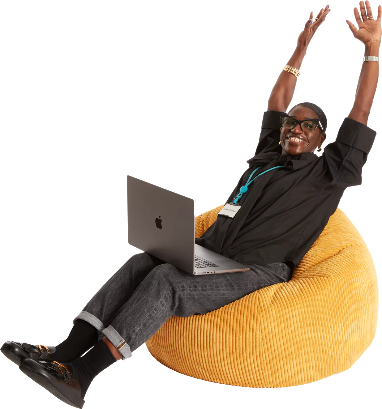 A man sitting on a bean bag chair with his laptop.