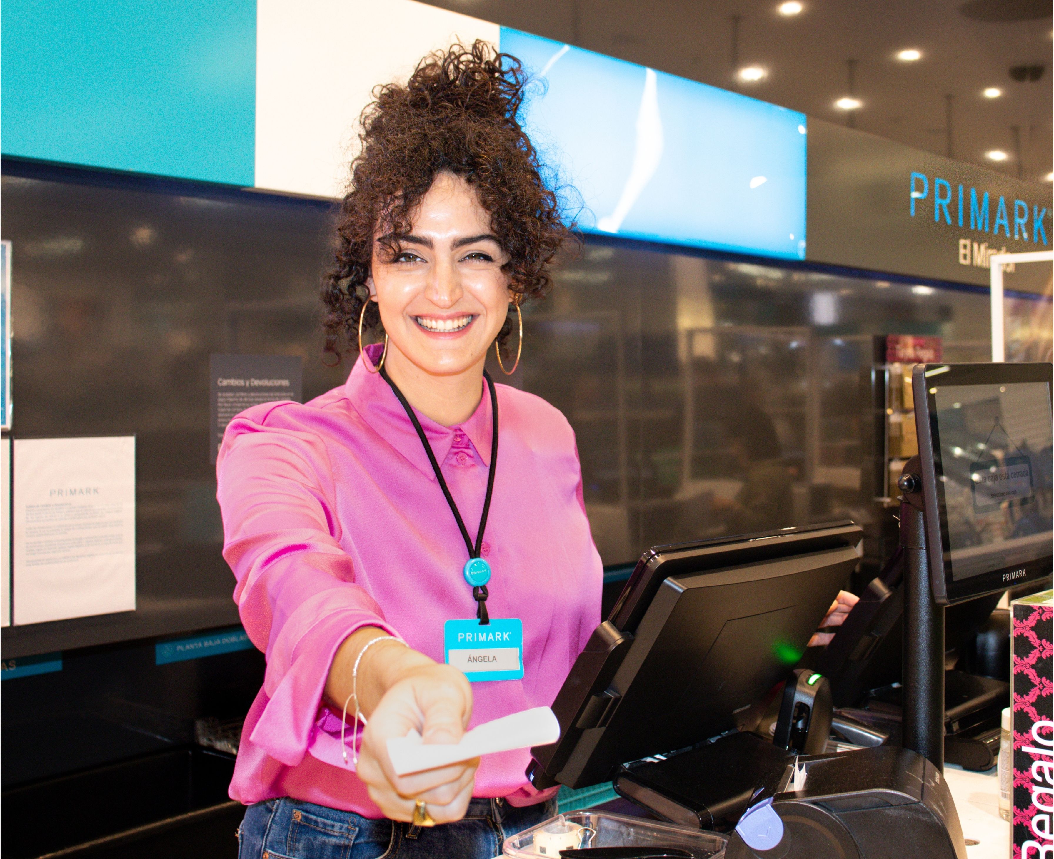 Colleague at cash register in Primark store