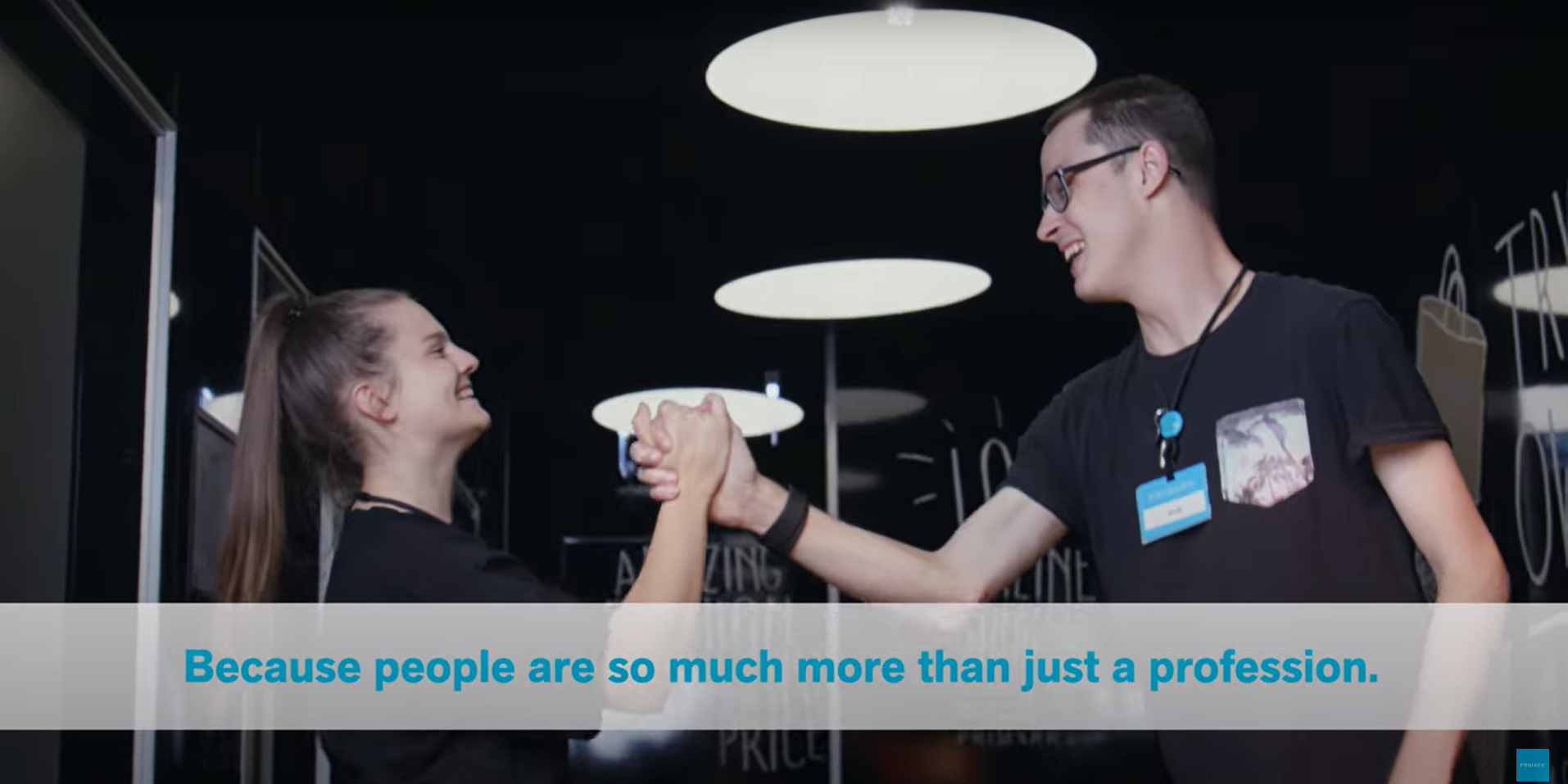 Colleagues smiling and holding hands in Primark store