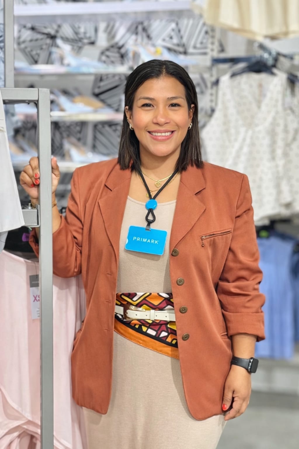 Colleague smiling at camera in store